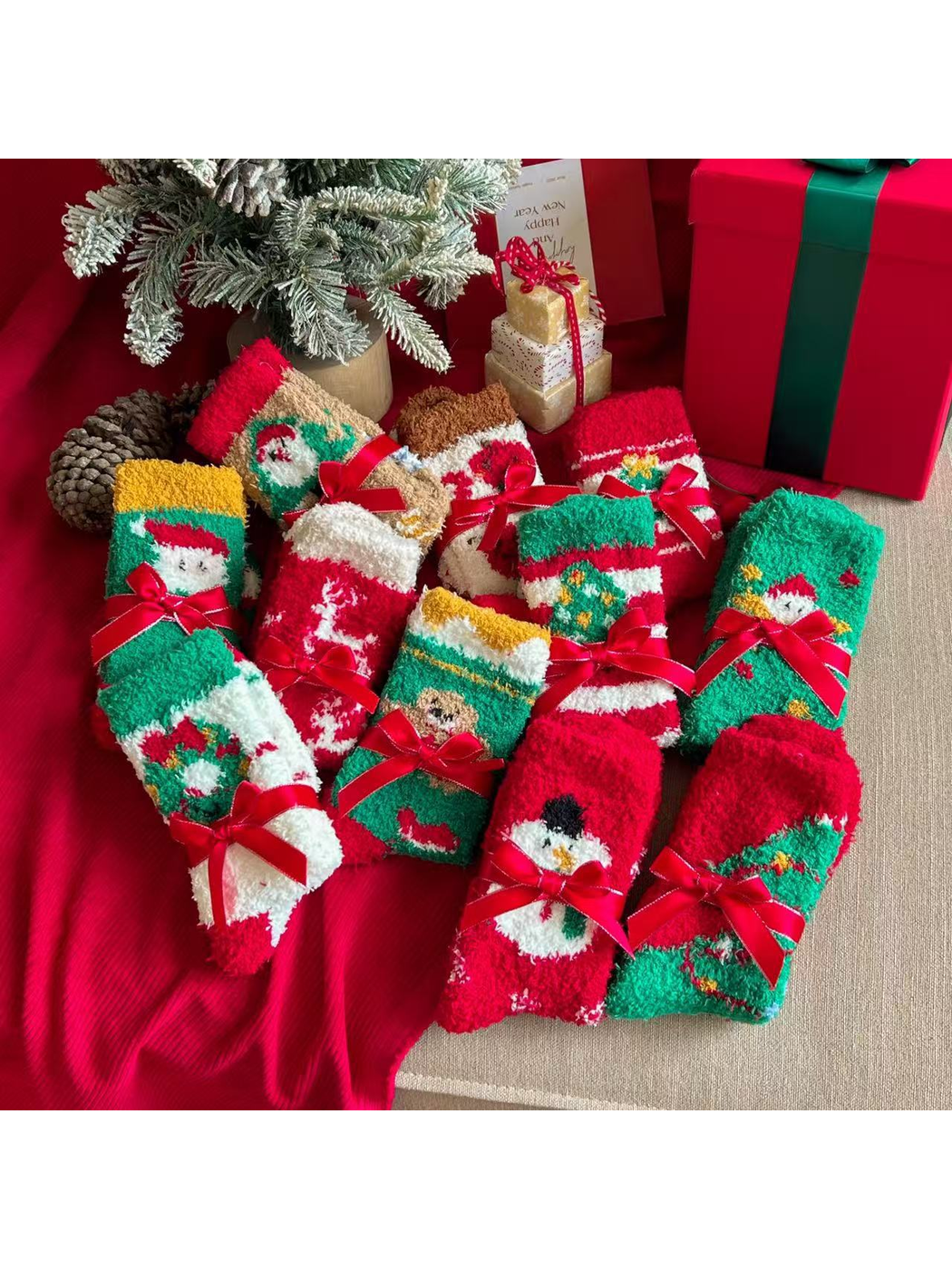 Assorted fuzzy Christmas crew socks bundled with red ribbons