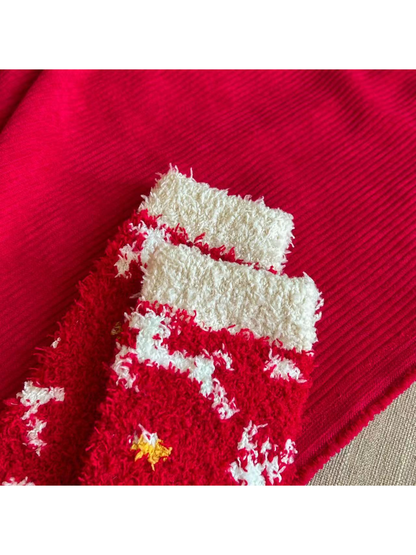 Close-up of the ivory cuff openings on red fuzzy Christmas socks