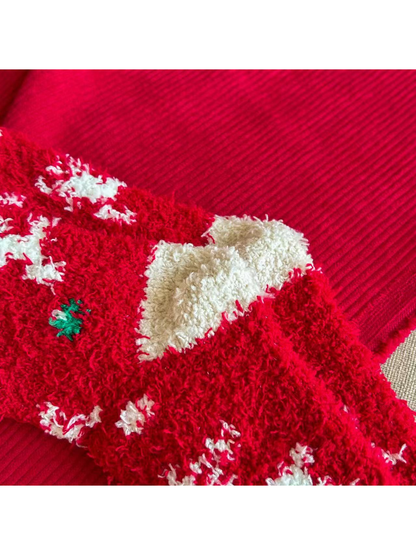 Close-up of the contrasting ivory heel section on red fuzzy Christmas socks