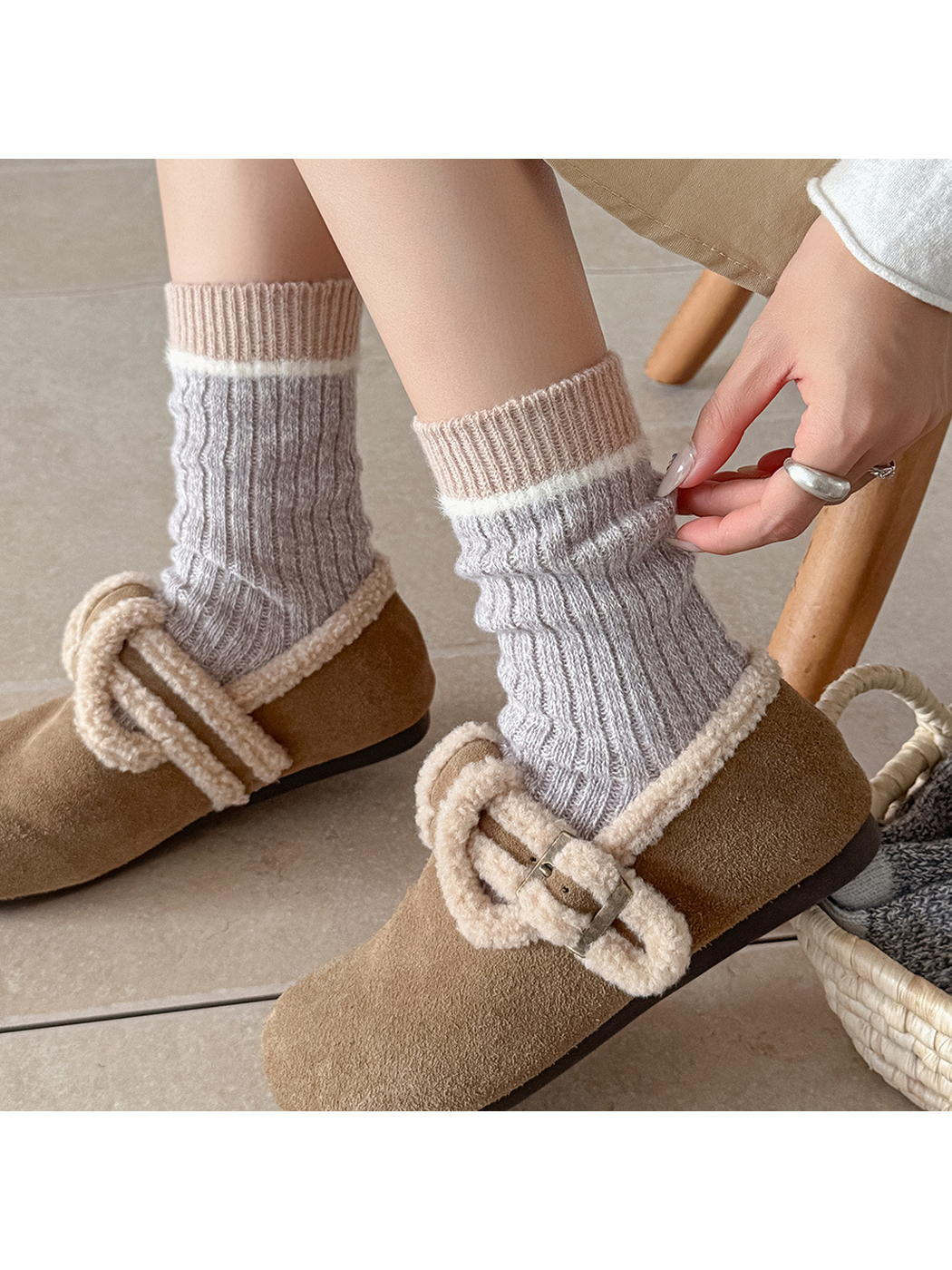 Close view of light gray crew socks with a fuzzy white stripe