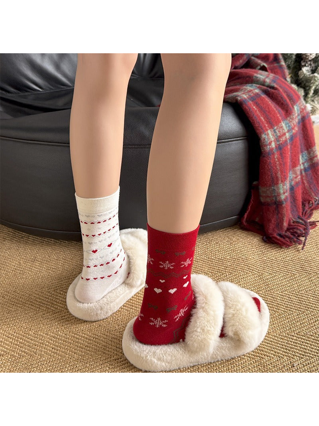 Red and ivory patterned crew socks worn with plush slippers