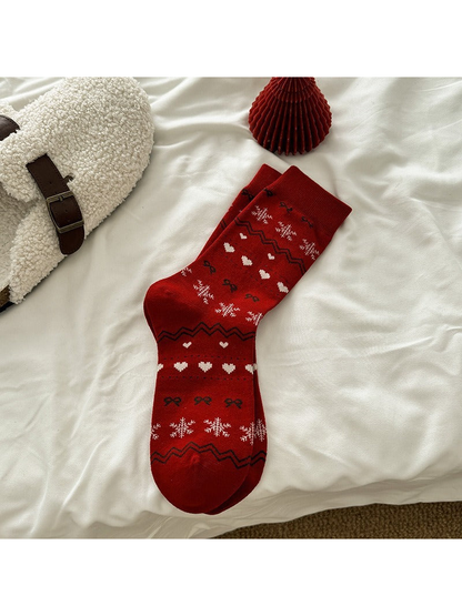 Red crew socks with snowflake, heart, bow and zigzag motifs