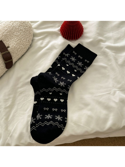 Black crew socks with snowflake, heart, bow and zigzag motifs