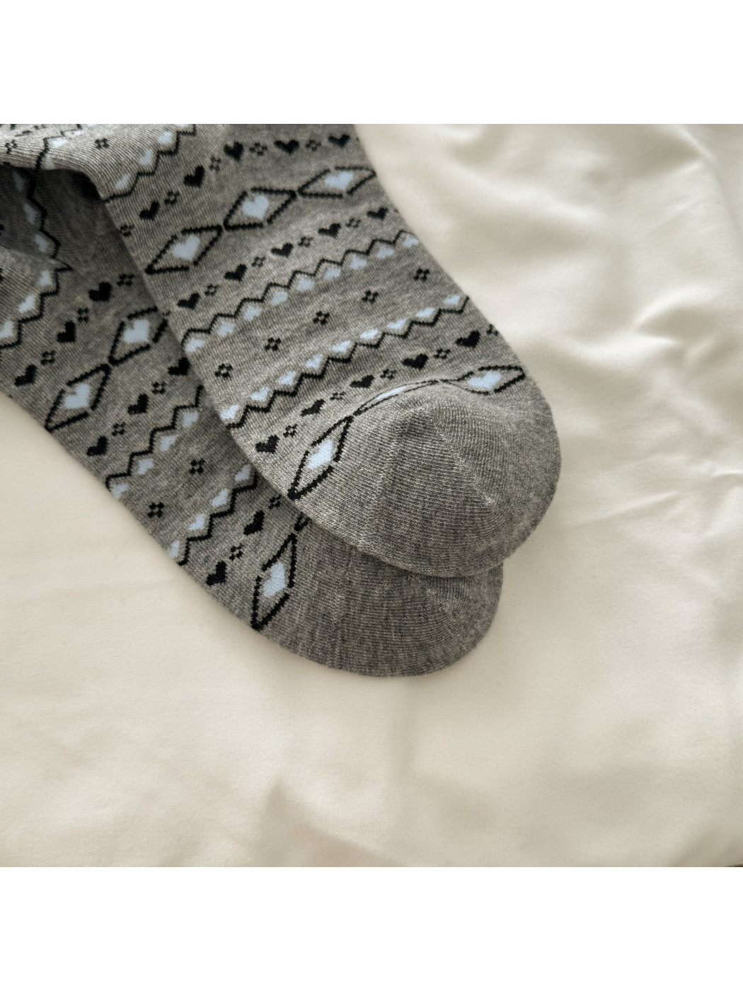 Close-up of the gray sock toe and geometric pattern
