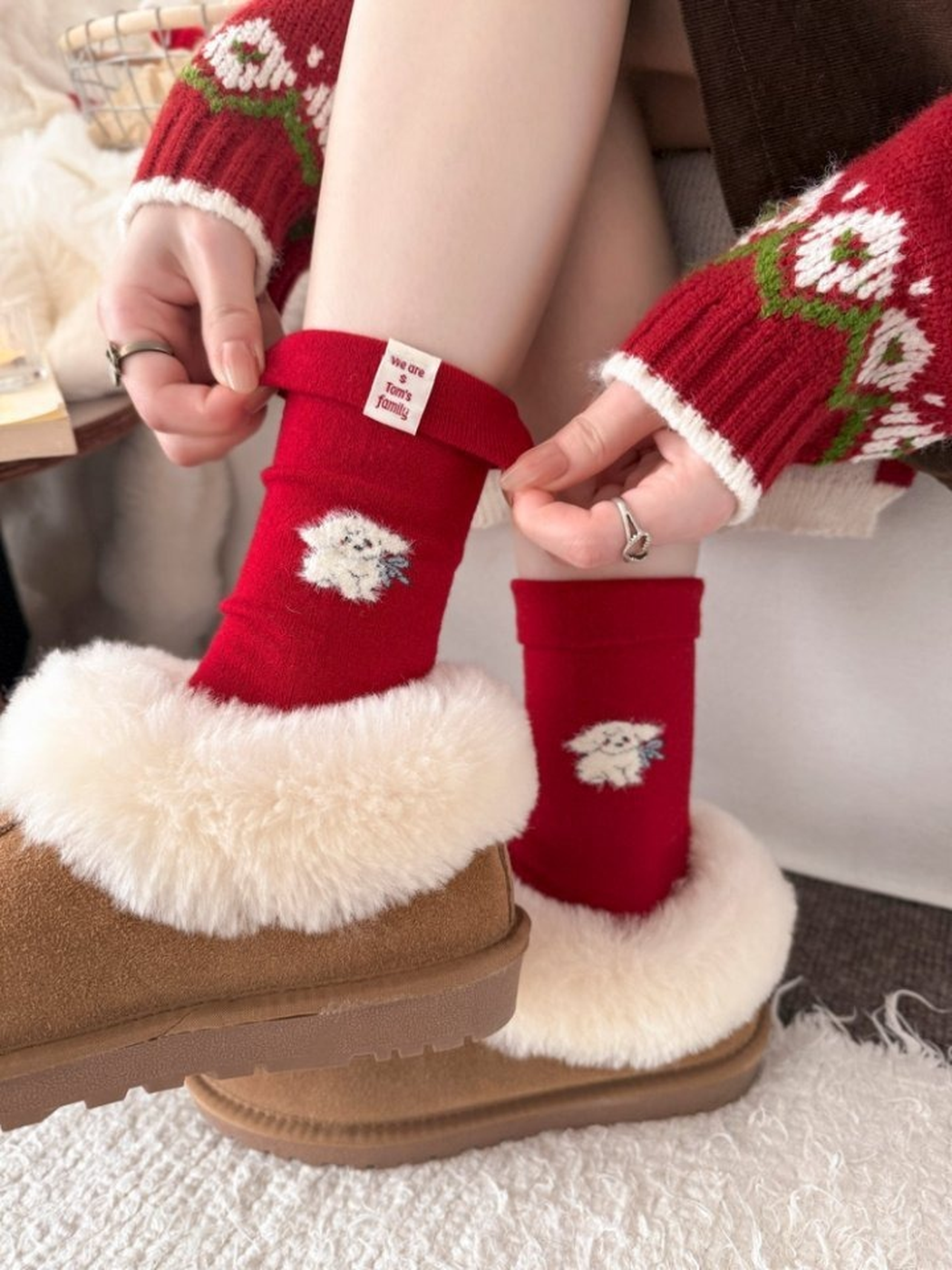 Red fuzzy-dog crew socks worn with fur-trimmed boots