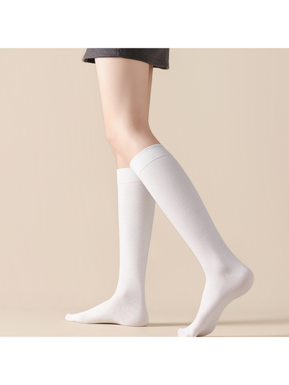 White knee-high socks worn in a standing pose