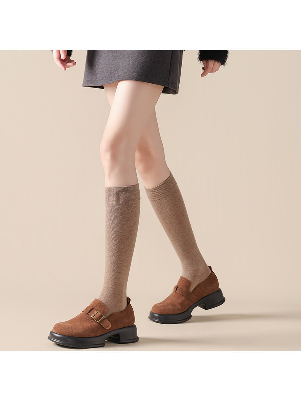 Oatmeal knee-high socks styled with brown buckle shoes