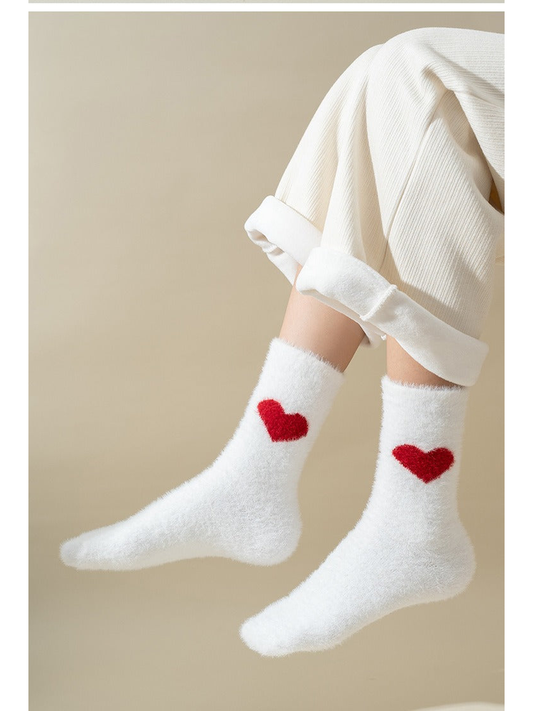 White fuzzy crew socks with one red heart on each sock