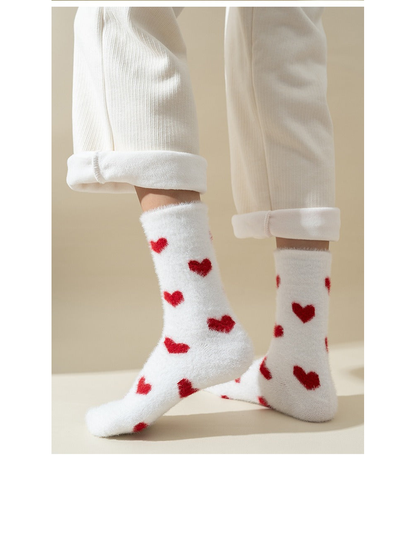 White fuzzy crew socks with scattered red heart motifs