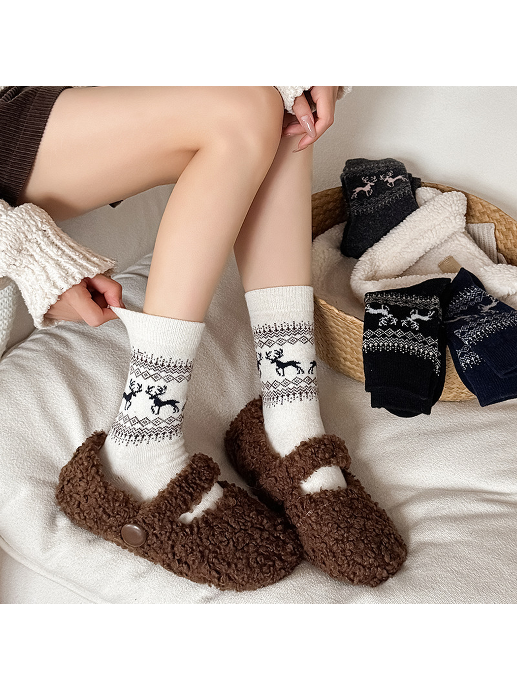 Ivory deer-pattern crew socks worn with brown slippers in a cozy indoor setting
