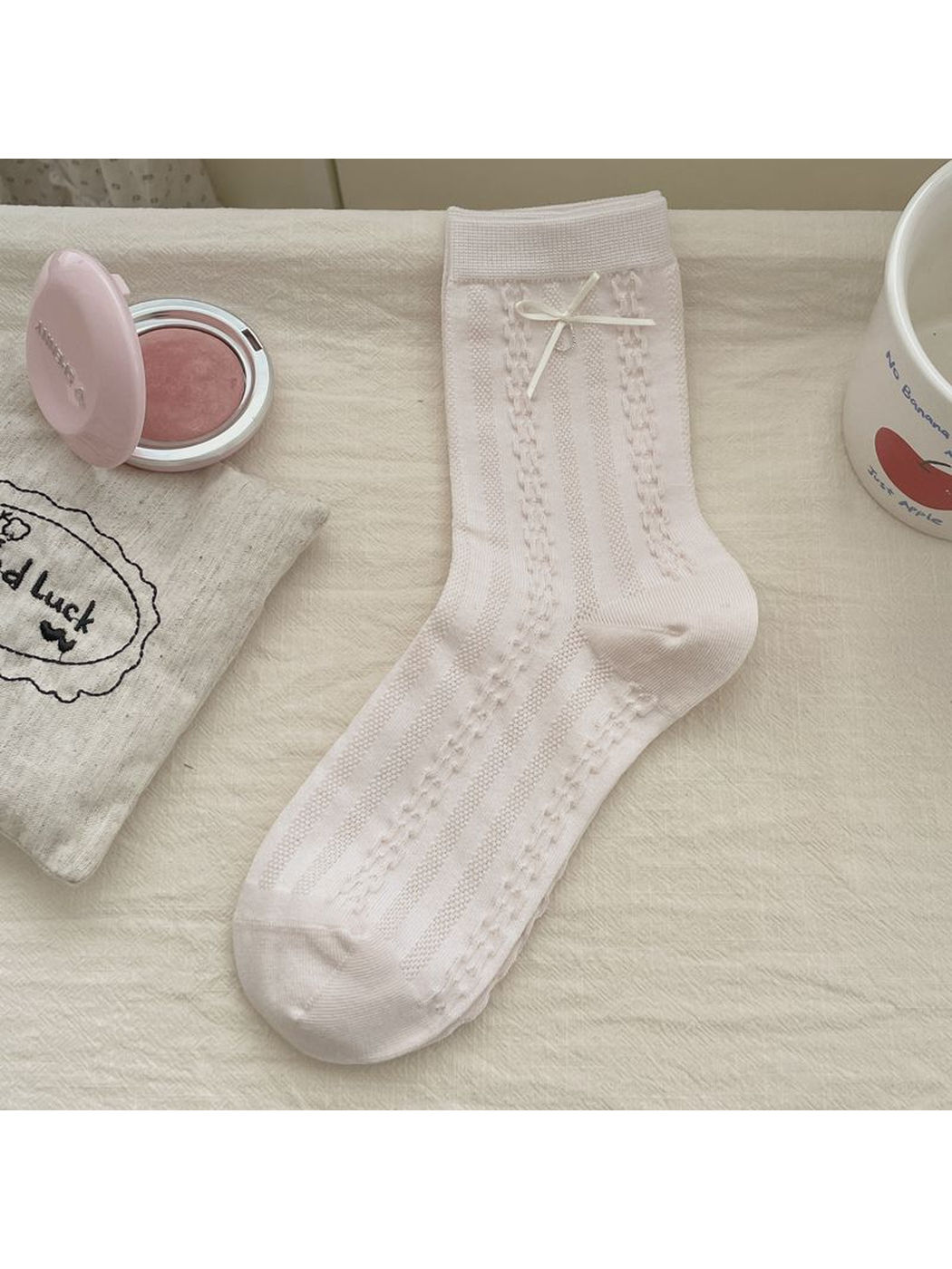 Light pink openwork crew sock with a small bow accent
