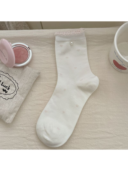 White ribbed crew sock with a pearl accent and pink ruffled cuff