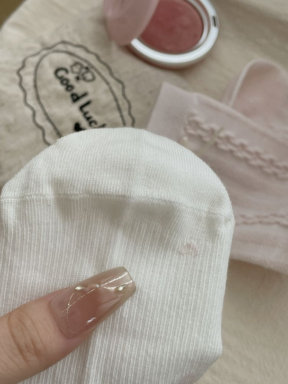Close-up of fine vertical ribbing across the white sock toe and foot