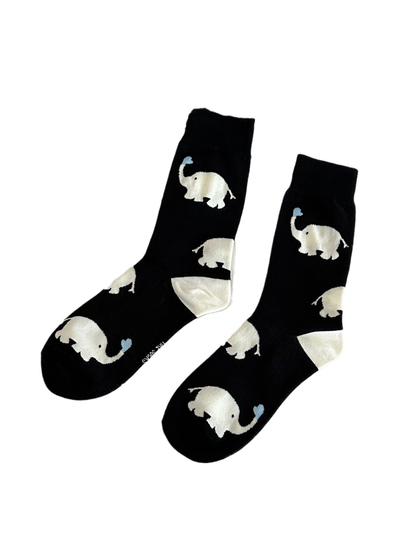 Black crew socks with white elephant motifs on a plain white background