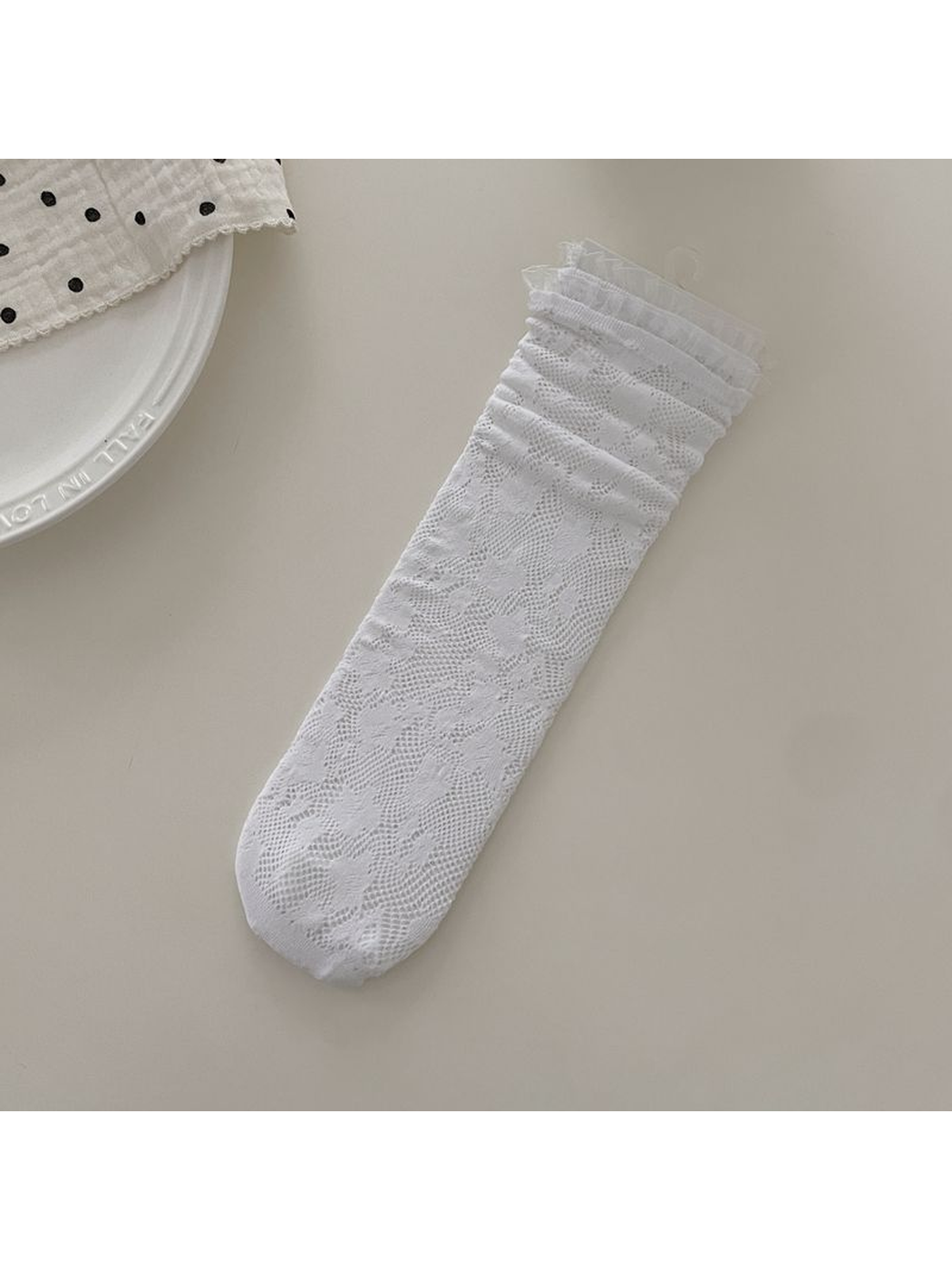 White floral openwork lace sock with ruffled cuff, flat display
