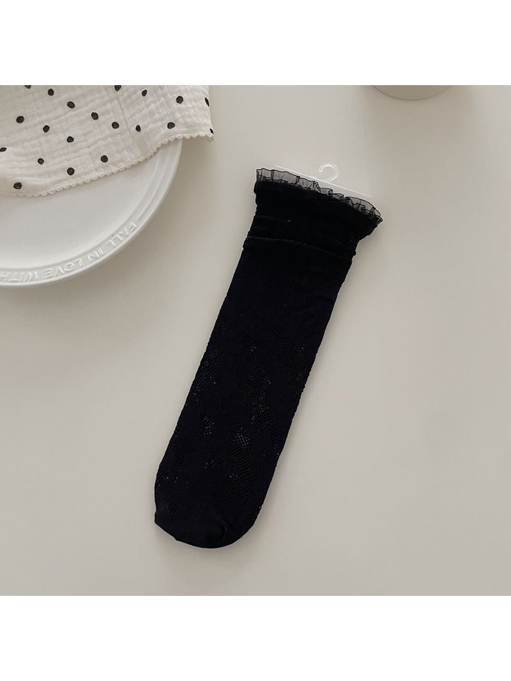 Black floral lace sock with ruffled cuff, flat display