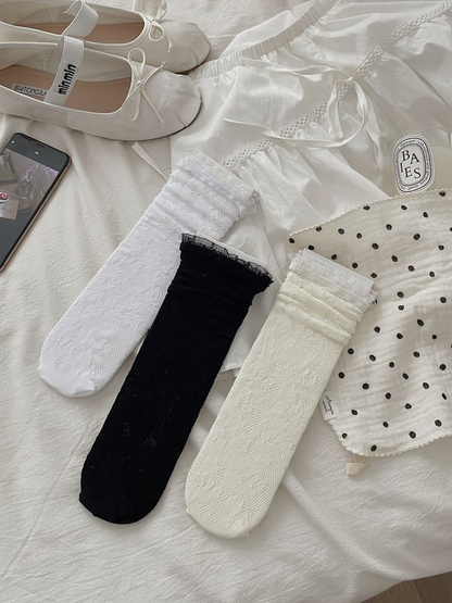 Black, white and ivory floral lace socks displayed together