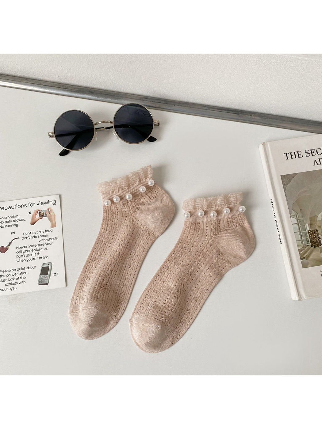 Light beige ankle socks with ruffled cuffs and pearl-like bead trim
