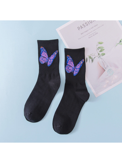 Black crew socks with purple and blue butterfly motifs