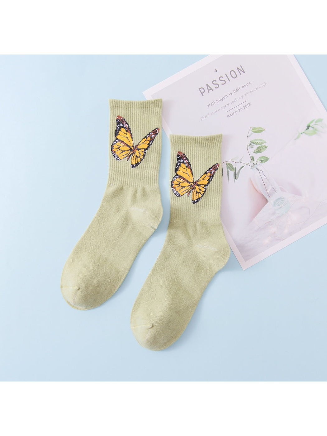 Green crew socks with yellow butterfly motifs