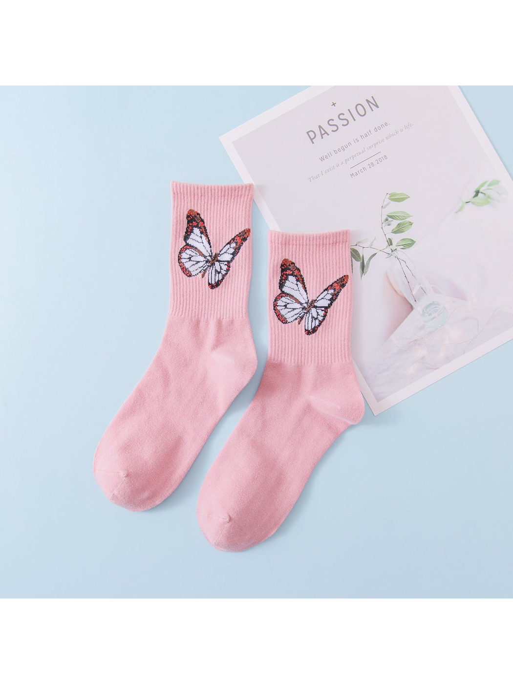 Light pink crew socks with pale butterfly motifs