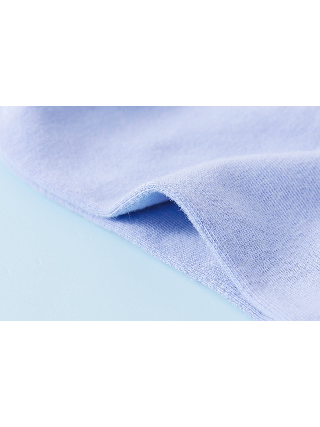 Close-up of the light blue sock fabric and finished folded edge