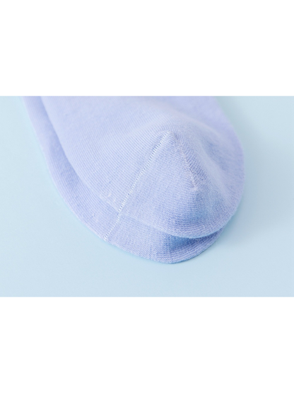 Close-up of the curved seam at the rounded light blue sock toe