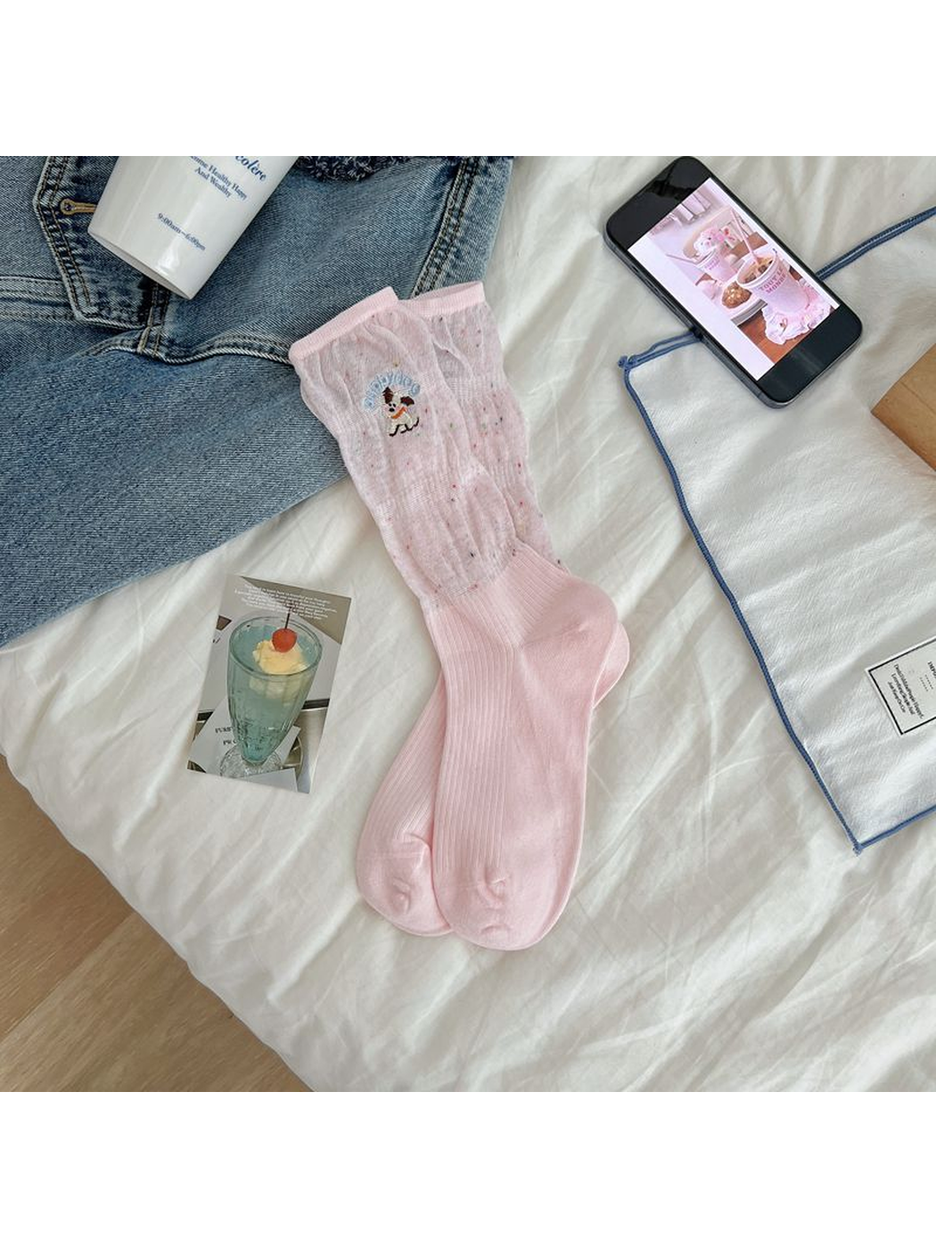 Light pink crew socks with a flecked upper section and embroidered dog motif