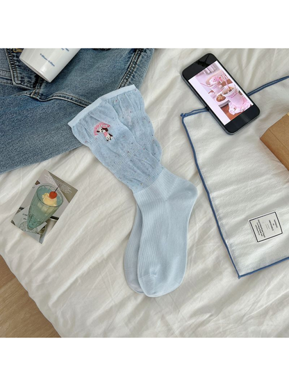 Light blue crew socks with a flecked upper section and embroidered dog motif