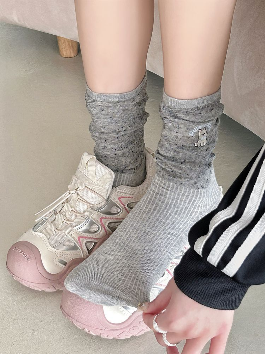 Heather gray embroidered crew socks worn with pink and white sneakers