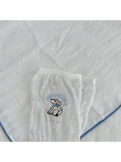 Close-up of the embroidered dog motif and multicolored flecks on a white sock