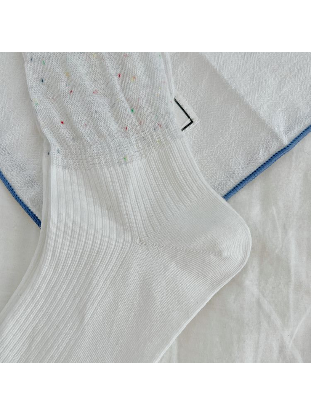 Close-up of the fine ribbing around the heel and foot of a white sock