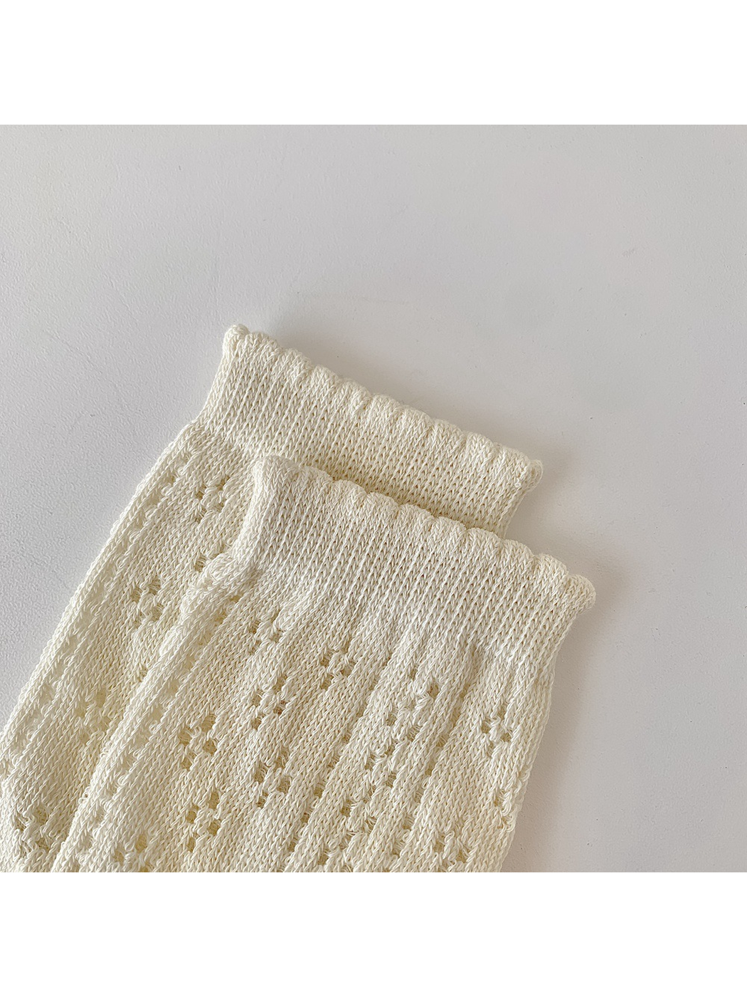 Close-up of the narrow ribbed cuffs and vertical pointelle columns