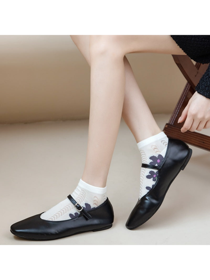 Ivory floral ankle socks styled with black Mary Jane shoes