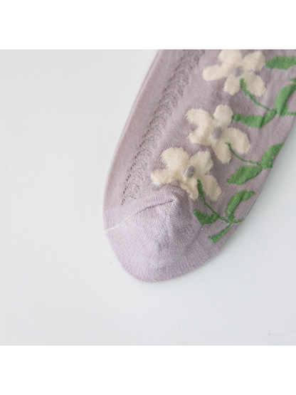 Close-up of the light purple sock toe, floral motif and openwork panel