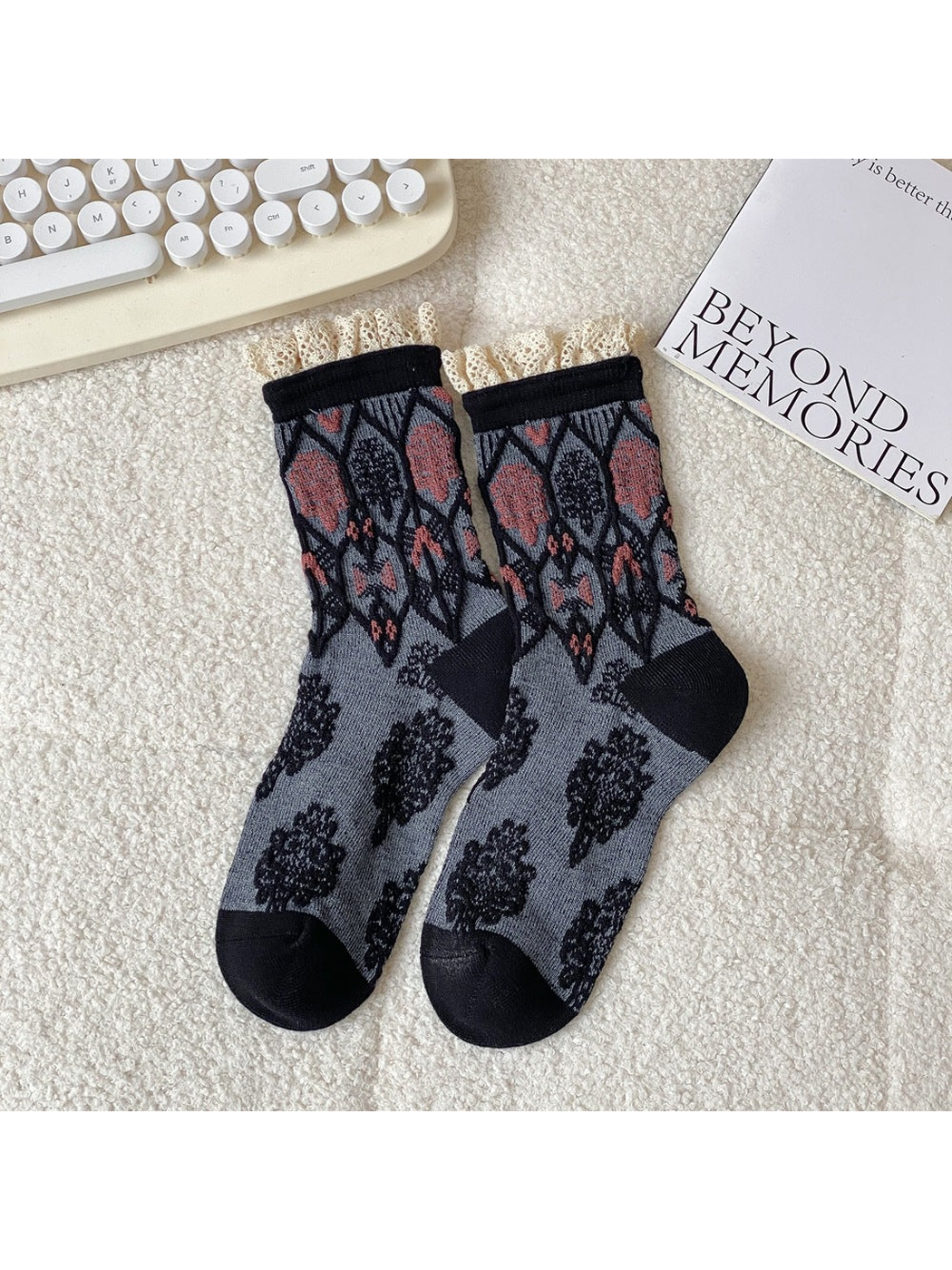 Black and gray crew socks with geometric motifs and lace-trimmed cuffs
