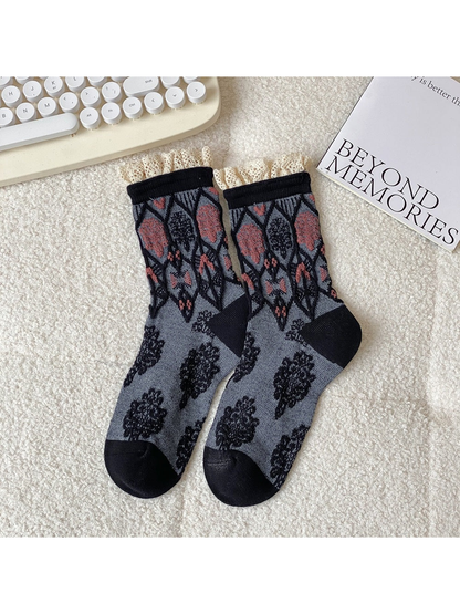Black and gray crew socks with geometric motifs and lace-trimmed cuffs