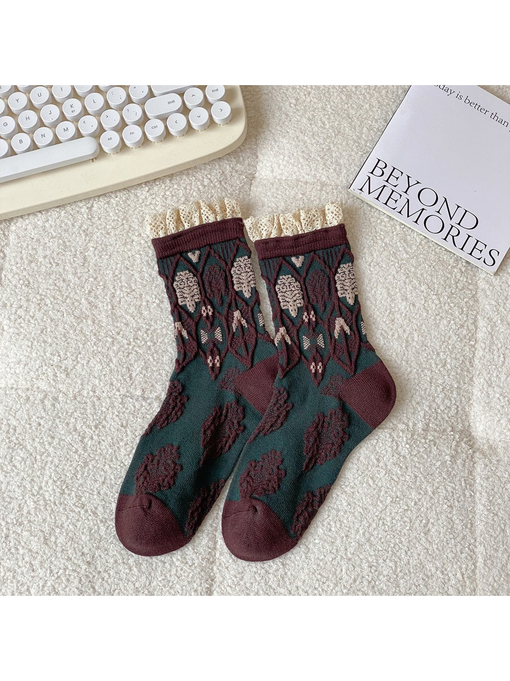 Dark green and brown crew socks with geometric motifs and lace-trimmed cuffs