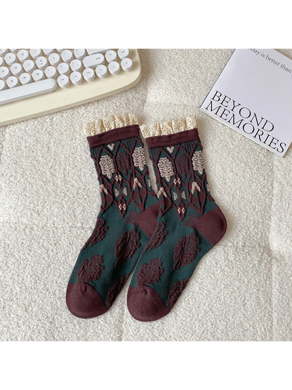 Dark green and brown crew socks with geometric motifs and lace-trimmed cuffs