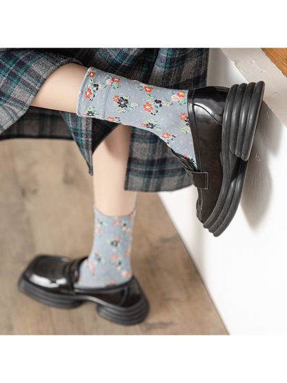 Light blue floral crew socks worn with black loafers