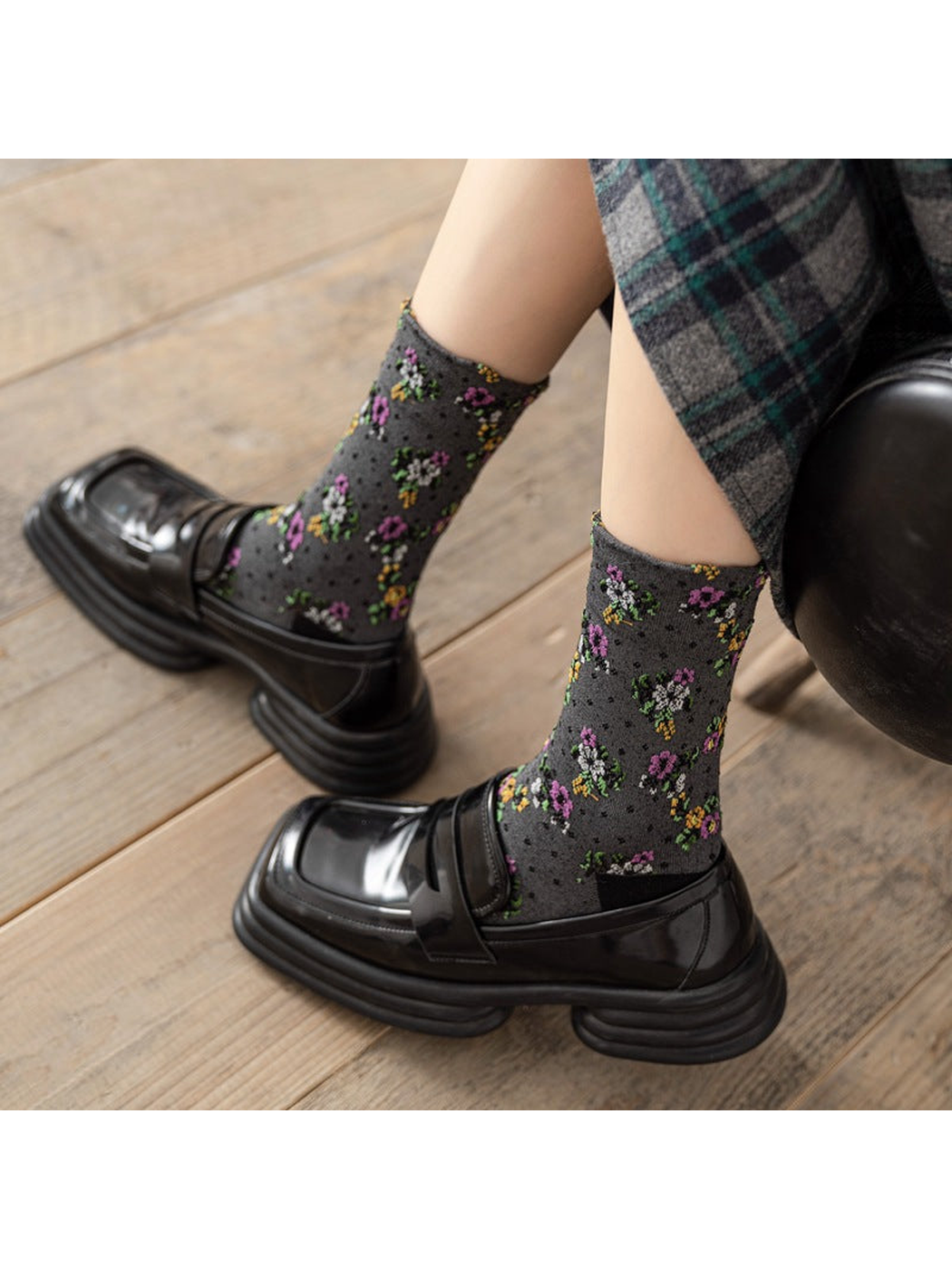 Dark gray floral crew socks worn with black loafers
