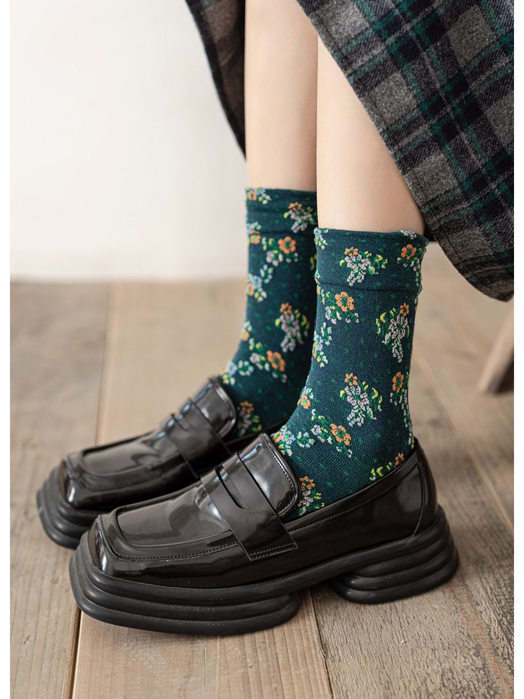 Dark green floral crew socks styled with black loafers