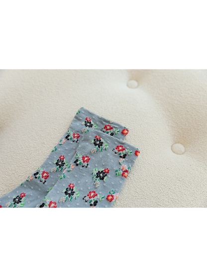 Close-up of floral clusters and dotted texture near the sock cuff
