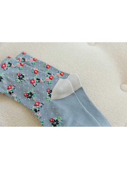 Close-up of pale contrasting heel panels on light blue floral socks