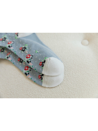 Close-up of the curved seam across contrasting sock toes