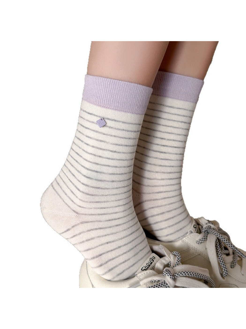 White striped crew socks with light purple cuffs worn with white sneakers