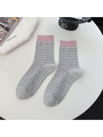 Light gray striped crew socks with contrasting pink cuffs