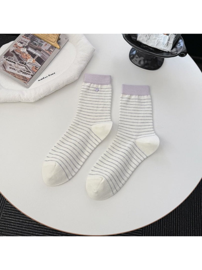 White striped crew socks with contrasting light purple cuffs