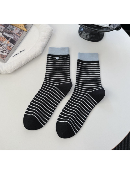 Black striped crew socks with contrasting light blue cuffs