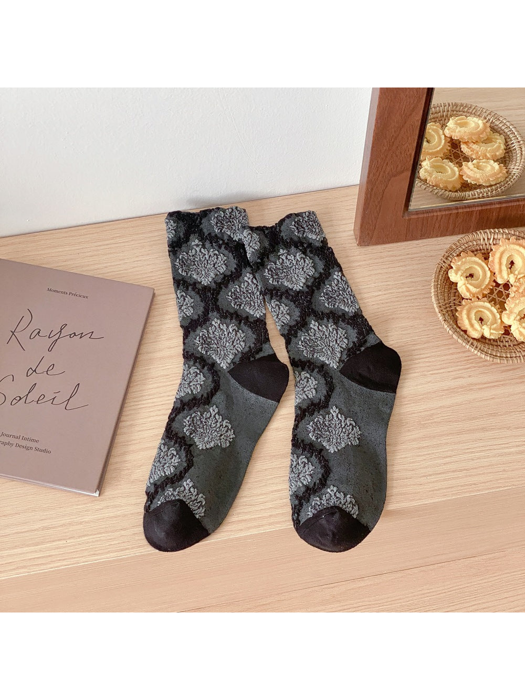 Black and gray patterned crew socks with contrasting toes and heels